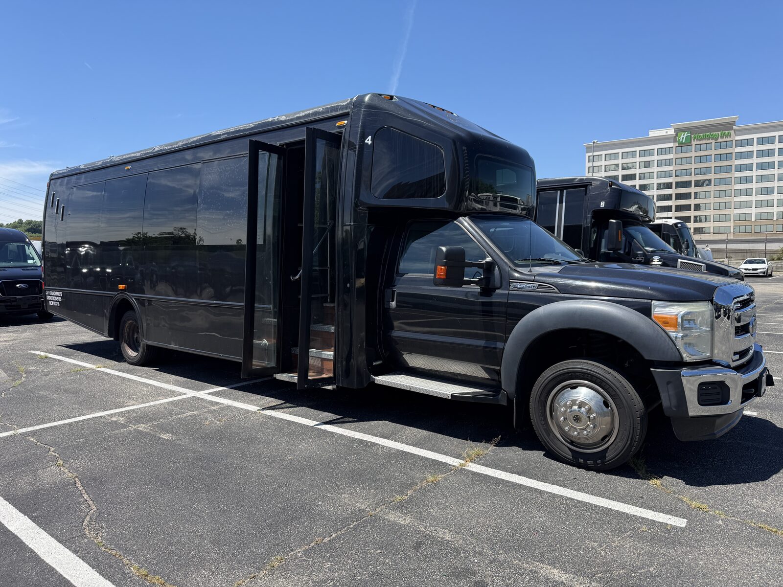Party Bus R Us black party bus exterior in daylight