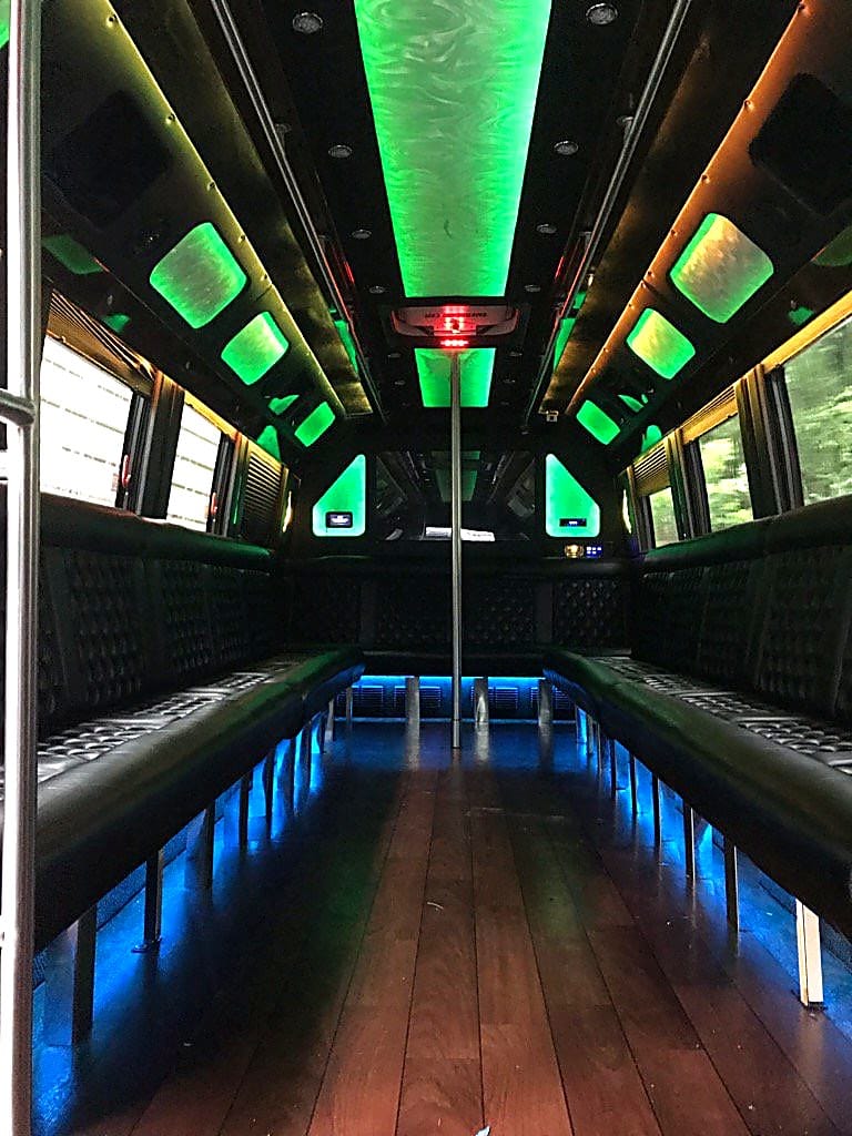 Wood-floor party bus interior with green LED