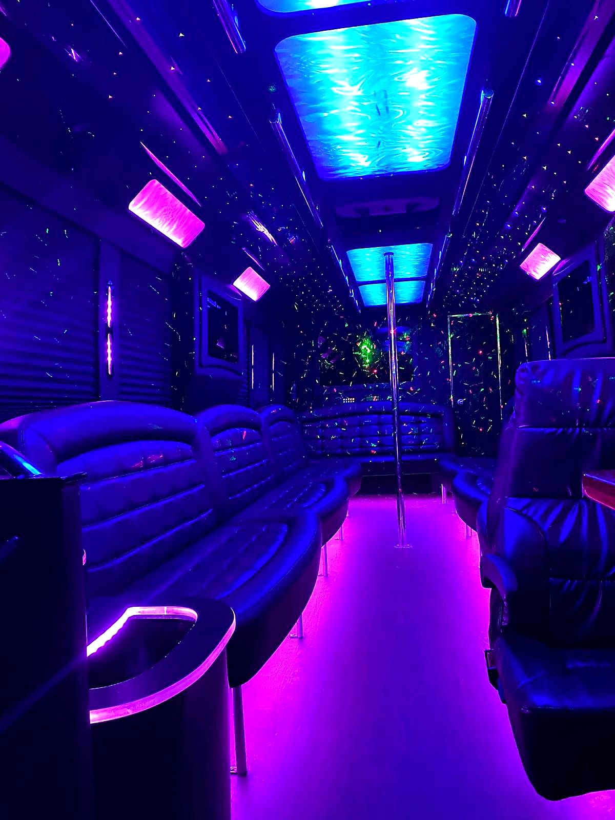 Royal purple LED party bus interior with captain chair and water-light ceiling