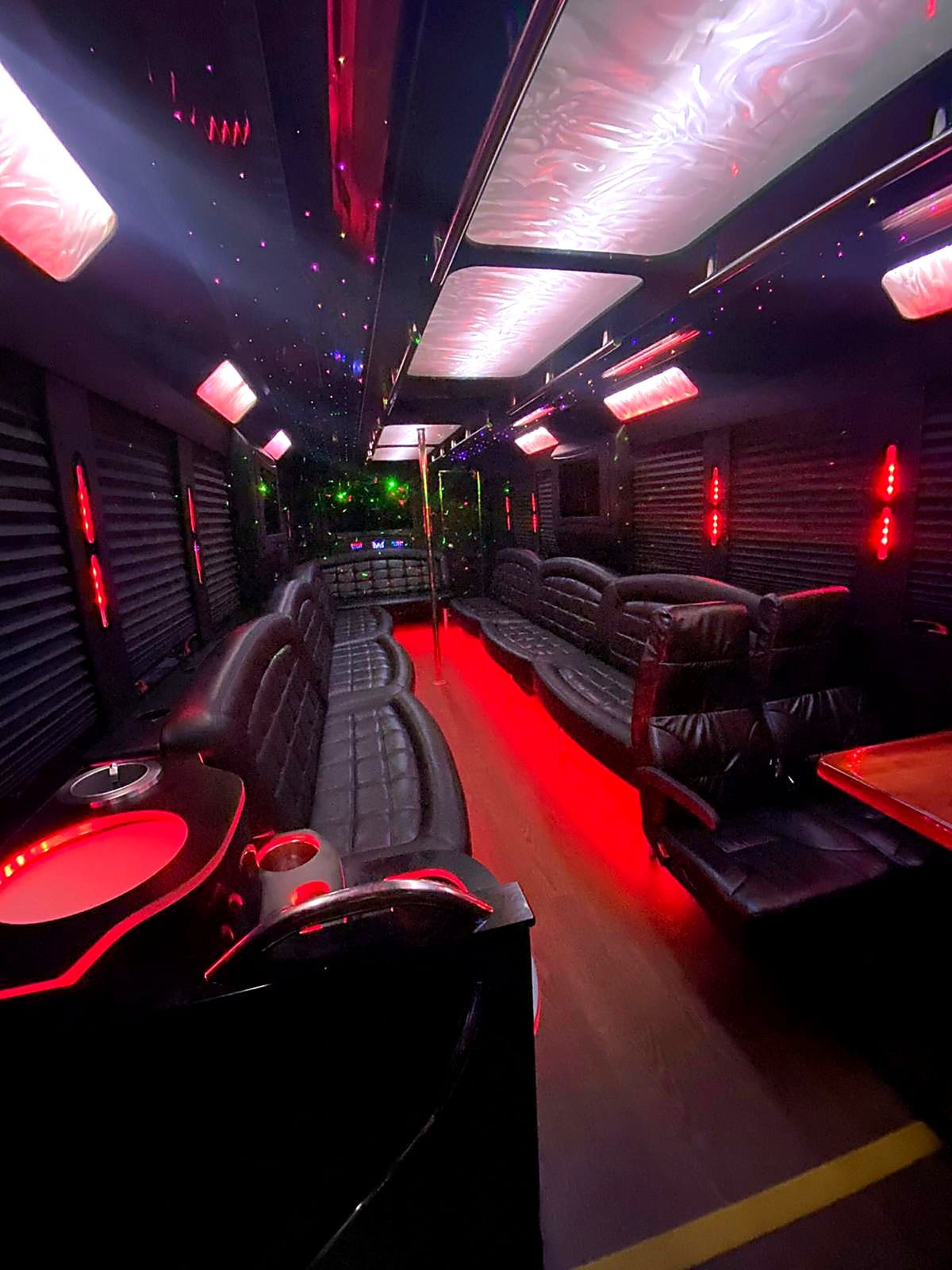 Crimson red LED party bus interior with captain chair and water-light ceiling